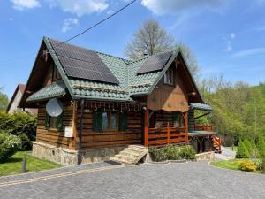 a house with solar panels on top of it at Czym Chata Bogata in Korbielów