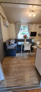 a living room with a couch and a table at Mobile Home Shelbox in Biograd na Moru
