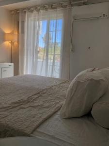 a bedroom with a large bed with a window at Pounta Beach House in Sounio