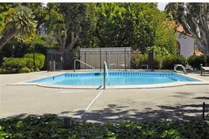 an empty swimming pool in a yard with trees at 629 Walk to Restaurants Close to Golf and Spa Luxury Inside the gates in Encinitas