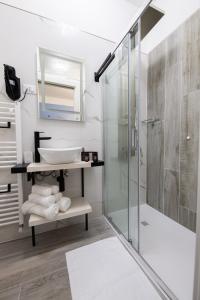 a bathroom with a sink and a shower at DOMORA BEDROOMS in Ortona