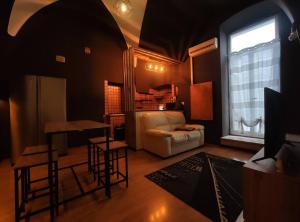 a living room with a white couch and a window at B&B Terrace09 in Castellana Grotte