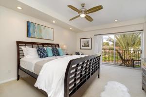 a bedroom with a bed and a ceiling fan at 633 Top Floor Corner Condo inside the gates of the Resort in Encinitas