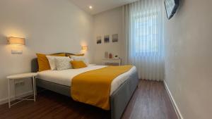 a bedroom with a large bed and a window at MyTrip Porto in Matosinhos