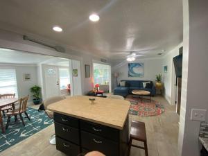 a kitchen and living room with a couch and a table at Rock Ridge I. Private and close to everything. in Vero Beach