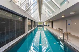 an indoor swimming pool with a skylight in a building at StayCentral - Cityviews on City Road Southbank in Melbourne