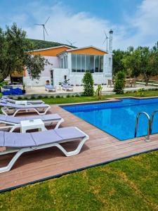 a villa with a swimming pool and a house at Alaçatı Beka House in Alacati