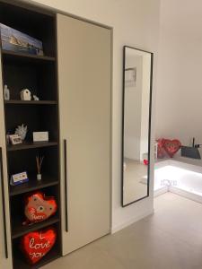 a room with a door and a mirror in it at Archimar House in Taranto