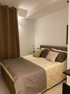 a bedroom with a large bed in a room at Archimar House in Taranto