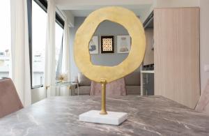 a large wooden mirror sitting on top of a table at MELMA PROPERTIES - ARIA-Piraeus Central Penthouse in Piraeus