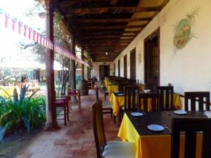 a restaurant with tables and chairs with yellow table cloth at Howard Johnson Hotel Rinconada de Los Andes in Los Andes