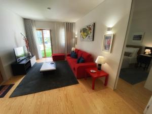 sala de estar con sofá rojo y mesa roja en TM Luxury Apartments Lisbon, en Lisboa