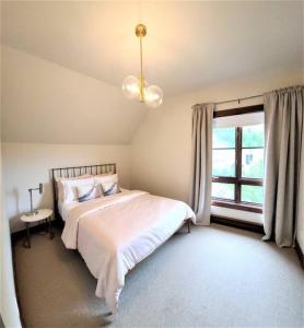 a bedroom with a large bed and a window at Tremblant Prestige - Étoile 1510-19 in Mont-Tremblant +12 photos