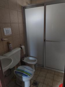 a bathroom with a toilet and a sink at LC House in Potrerillos +9 photos