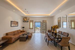 a living room with a couch and a table at SANTORINI GRAND LUXURY VILLAS in Imerovigli