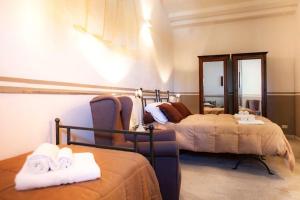 a hotel room with two beds and a mirror at ARBARIA APPARTAMENTI EX ARBARIA in Trapani