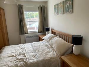 a bedroom with a bed and a window at The Bank in Lewes