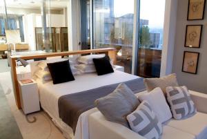 a bedroom with a large white bed with black pillows at Sheraton São Paulo WTC Hotel in Sao Paulo