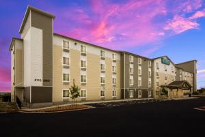 a rendering of a hotel with a building at WoodSpring Suites Austin Central in Austin