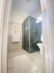 W łazience znajduje się przeszklony prysznic i toaleta. w obiekcie Mambaí Inn w mieście Mambaí
