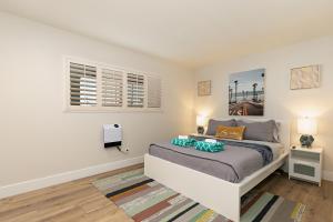 a bedroom with a bed and two windows at 106B New Renovation! Huge Patio with Harbor View in Oceanside +30 photos