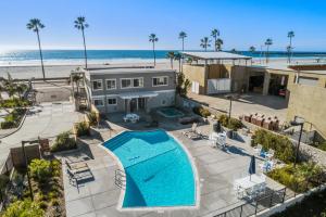 an aerial view of a house with a swimming pool and the beach at 106B New Renovation! Huge Patio with Harbor View in Oceanside