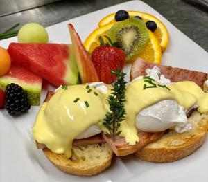 a plate of food with bread with eggs and fruit at The Latch Inn in Sidney