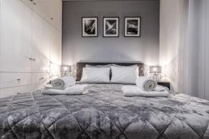 a bedroom with a large bed with two pillows on it at Luxury Beach House in Volos