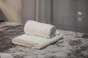 a stack of towels sitting on top of a bed at Luxury Beach House in Volos +21 photos