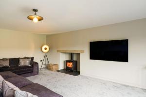 a living room with a couch and a fire place at Archstone House in Blackburn