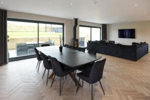 a dining room with a black table and chairs at Mylstone House in Blackburn