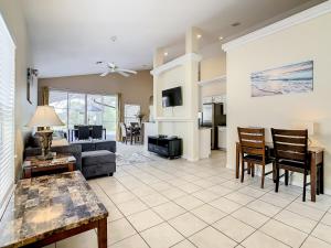 a living room with a couch and a table at Family retreat w pool near Disney & parks in Orlando