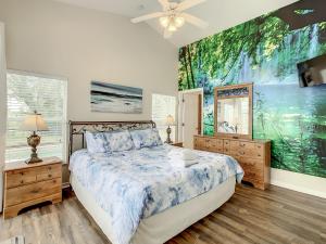 a bedroom with a bed and a painting on the wall at Family retreat w pool near Disney & parks in Orlando +80 photos