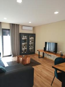 a living room with a couch and a table at Casa do Alfaiate - Douro in Peso da Régua