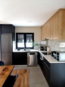 a kitchen with wooden cabinets and a counter top at Casa do Alfaiate - Douro in Peso da Régua