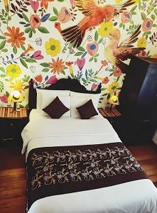 - une chambre avec un lit et un papier peint floral dans l'établissement Casona Dorada Hotel Cusco, à Cusco