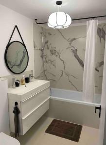 a bathroom with a sink and a mirror at Appartement d'exception, vue Saint-Tropez in Saint-Tropez