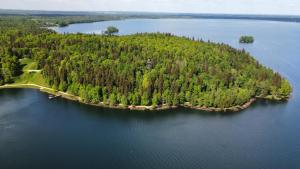 an island in the middle of a large body of water at Laivu Māja in Alūksne