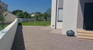 a white wall with a vase on the side of a house at Villa Ulika in Fažana