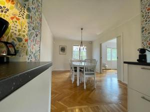 a kitchen and dining room with a table and chairs at Björkholm - Villa in Målilla in Målilla