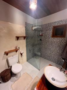 a bathroom with a shower and a toilet and a sink at Potxi & Cabana in Guriú
