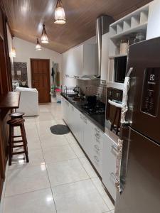 a kitchen with white cabinets and a black refrigerator at Potxi & Cabana in Guriú