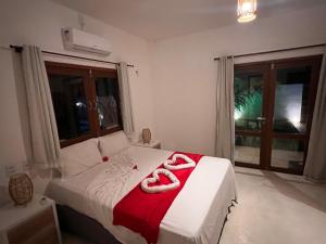 a bedroom with a bed with two towels on it at Potxi & Cabana in Guriú +14 photos