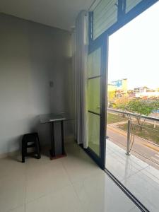 a room with a table and a large window at Adrian´s Hotel in Pucallpa