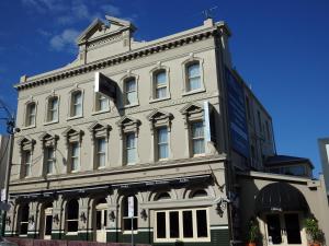 a large white building on the corner of a street at The Glenferrie Hotel Hawthorn in Melbourne