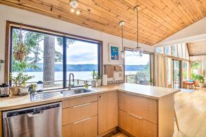 a kitchen with a sink and a large window at Trail's End Cabin in Lilliwaup