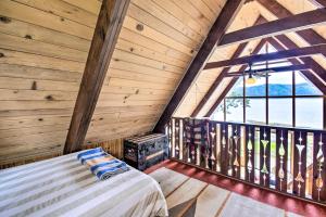 a bedroom in a log cabin with a bed and a stove at Trail's End Cabin in Lilliwaup