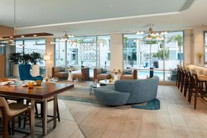 a dining room with tables and chairs and a restaurant at Courtyard by Marriott Santa Barbara Downtown in Santa Barbara