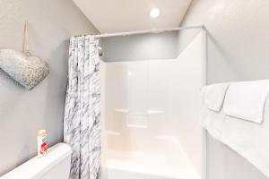 a bathroom with a shower curtain and a toilet at Making Branson Memories - Unit 1 in Branson