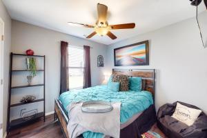 a bedroom with a bed and a ceiling fan at Making Branson Memories - Unit 1 in Branson
